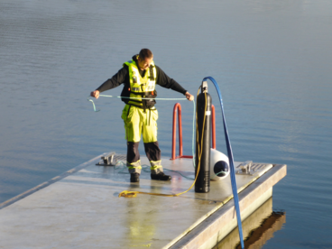 An aquaculture expert about to drop in some on-demand oxygen from the floating pier at the innovation center.  